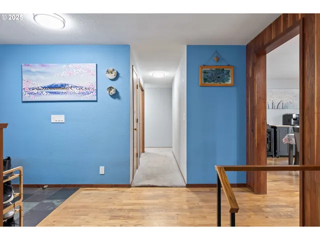 a spacious bedroom with a bed and a chandelier