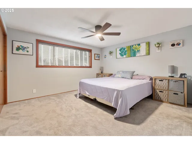a spacious bedroom with a bed and a chandelier