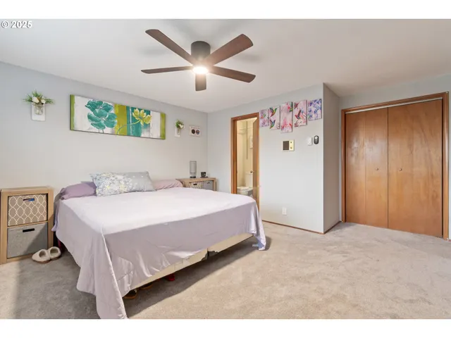 a bedroom with a large bed and a chandelier