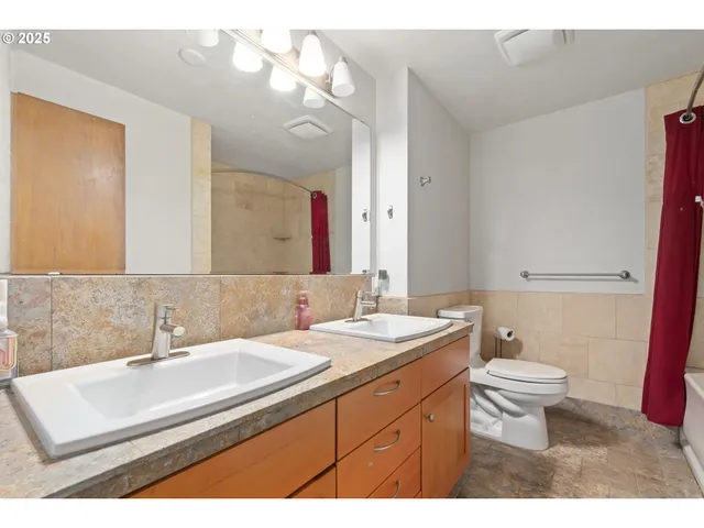 a bathroom with a sink a mirror and a shower