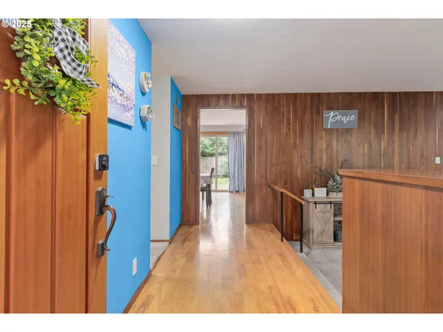a living room with furniture a large window and potted plants