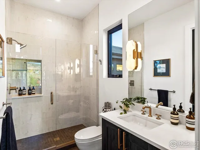 a bedroom with a bed and a flat tv screen on dresser