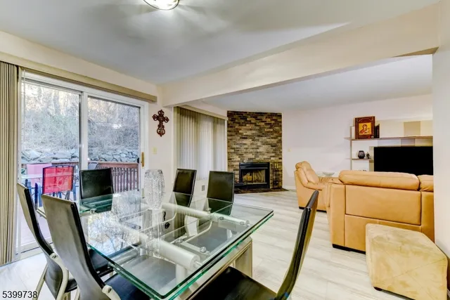 a living room with furniture a flat screen tv and a floor to ceiling window