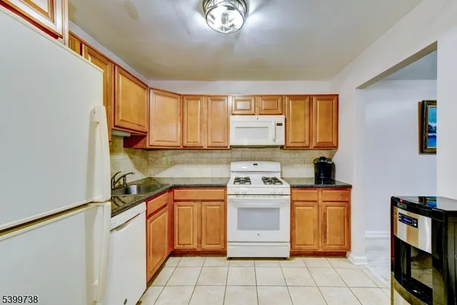 a kitchen with a stove a sink and a refrigerator