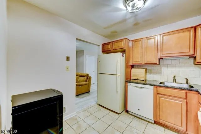 a kitchen with a refrigerator and a sink