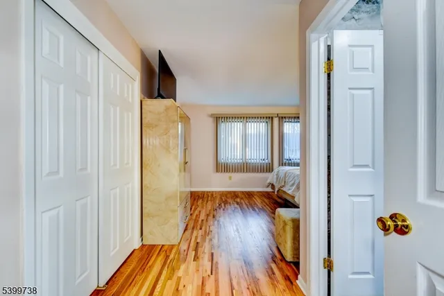 a view of hallway with wooden floor and stairs
