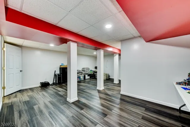 a room with lots of wooden furniture and white walls