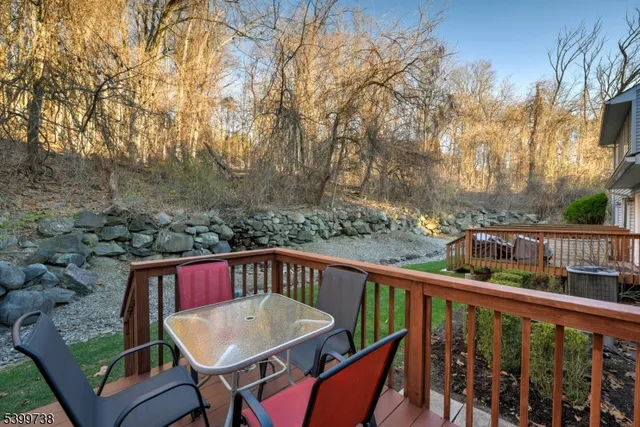 a view of a balcony with wooden floor and outdoor seating