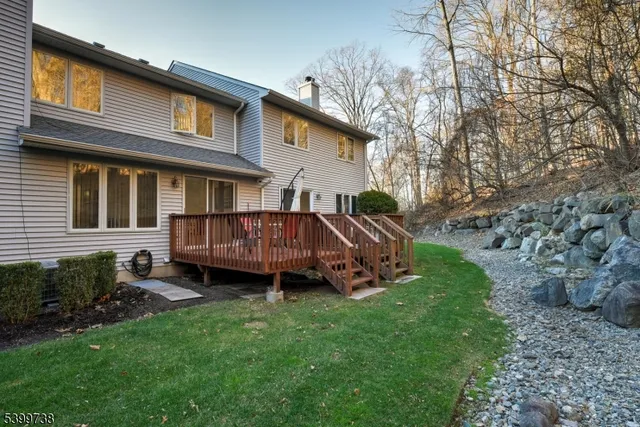 a view of a house with a yard and deck