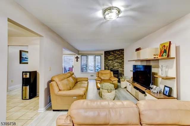 a living room with fireplace furniture and a wooden floor