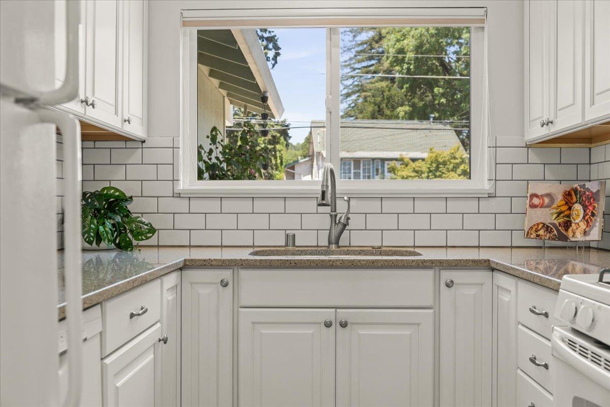 115 Hames Road Watsonville, CA 95076 - Photo 14 of 32 a kitchen with stainless steel appliances white cabinets and a window