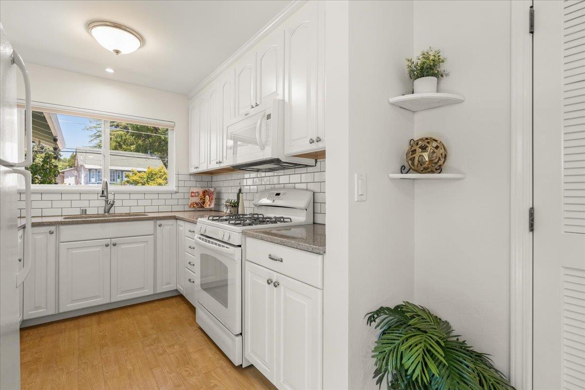 115 Hames Road Watsonville, CA 95076 - Photo 15 of 32 a kitchen with a white cabinets and window