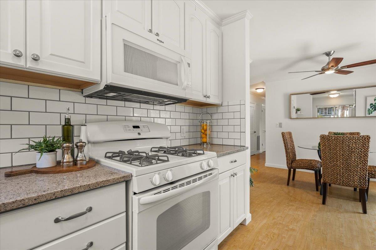 115 Hames Road Watsonville, CA 95076 - Photo 16 of 32 a kitchen with granite countertop a sink stove and white cabinets