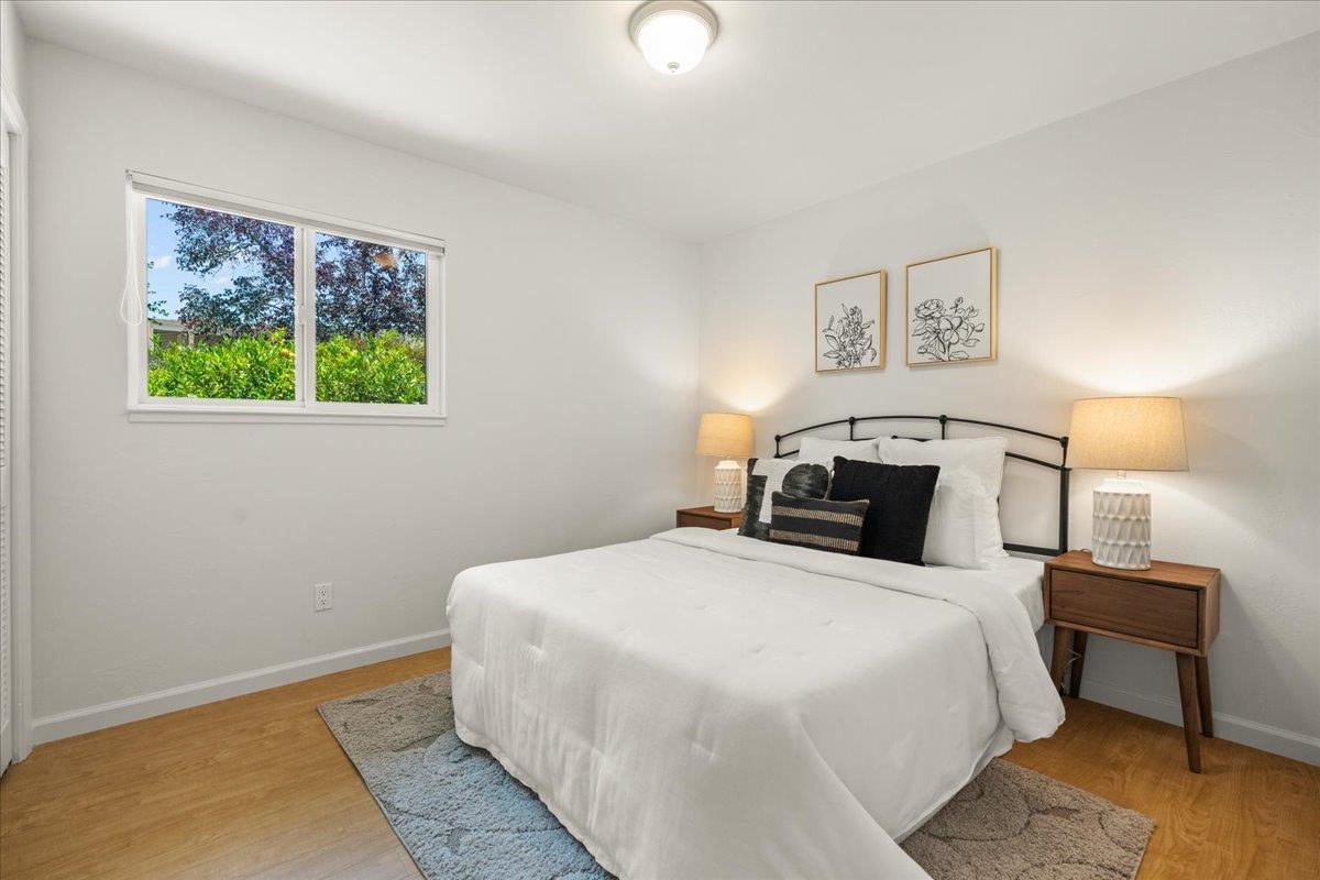 115 Hames Road Watsonville, CA 95076 - Photo 22 of 32 a bedroom with a bed and a lamp on dresser