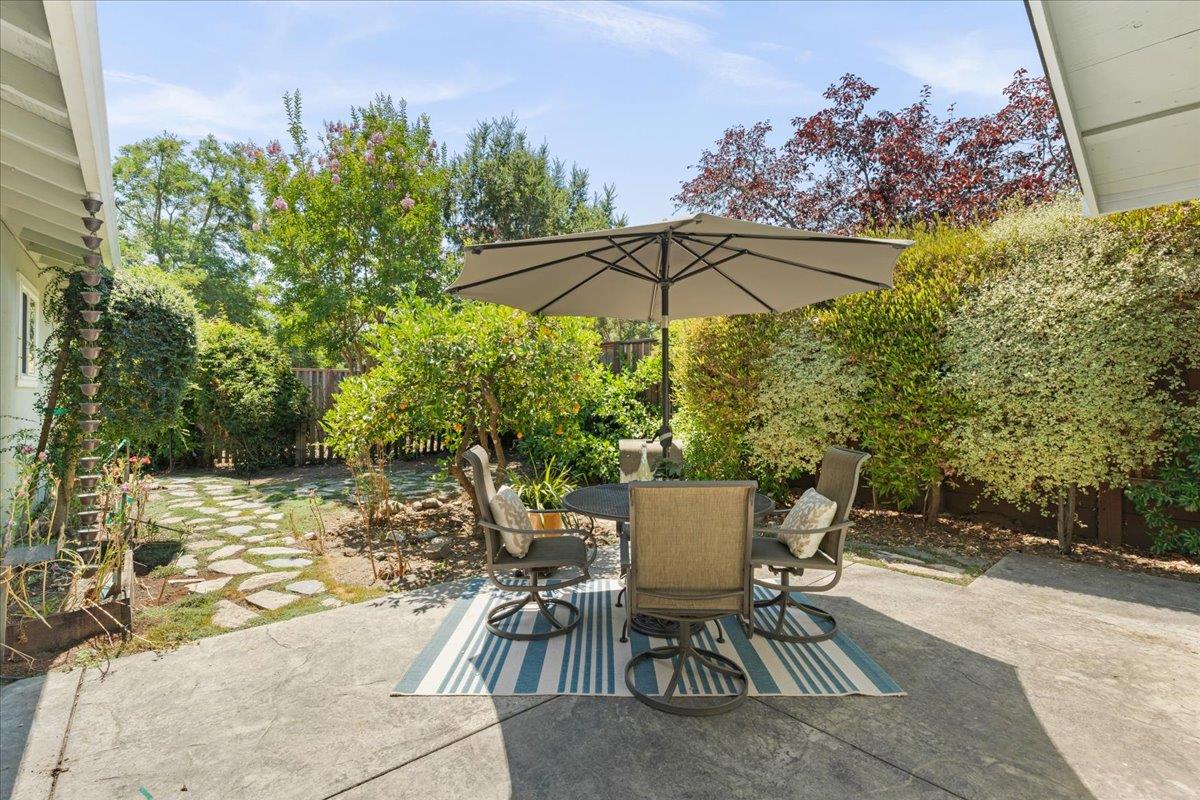115 Hames Road Watsonville, CA 95076 - Photo 25 of 32 a view of a patio with table and chairs under an umbrella