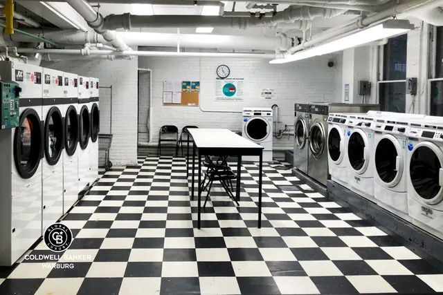 a kitchen with a checkered floor and white cabinets