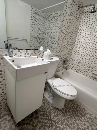 a bathroom with a sink toilet and a mirror
