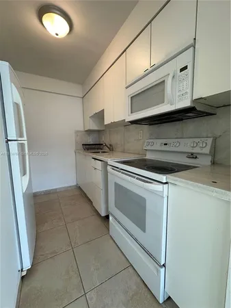a kitchen with stainless steel appliances granite countertop a stove a microwave and a refrigerator