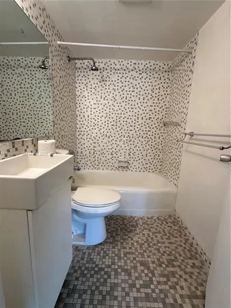 a bathroom with a sink a toilet and a shower
