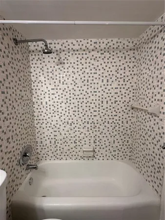 a bathroom with a bathtub and shower