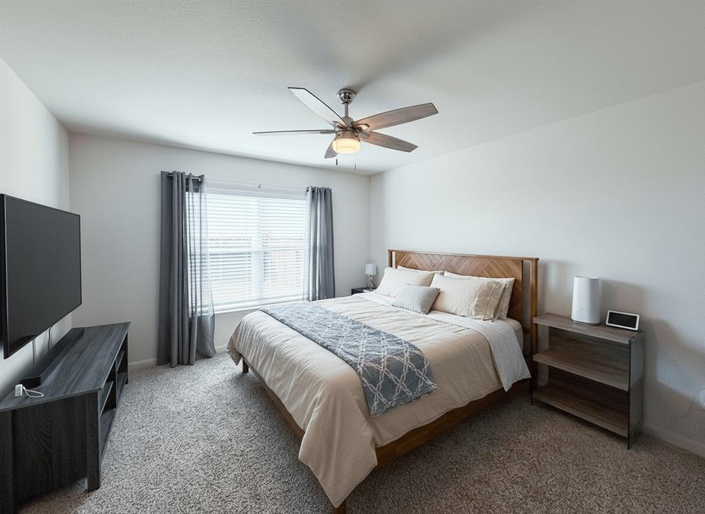 13507 Granite Park Road Ponder, TX 76259 - Photo 13 of 28 a bedroom with a bed and a flat screen tv