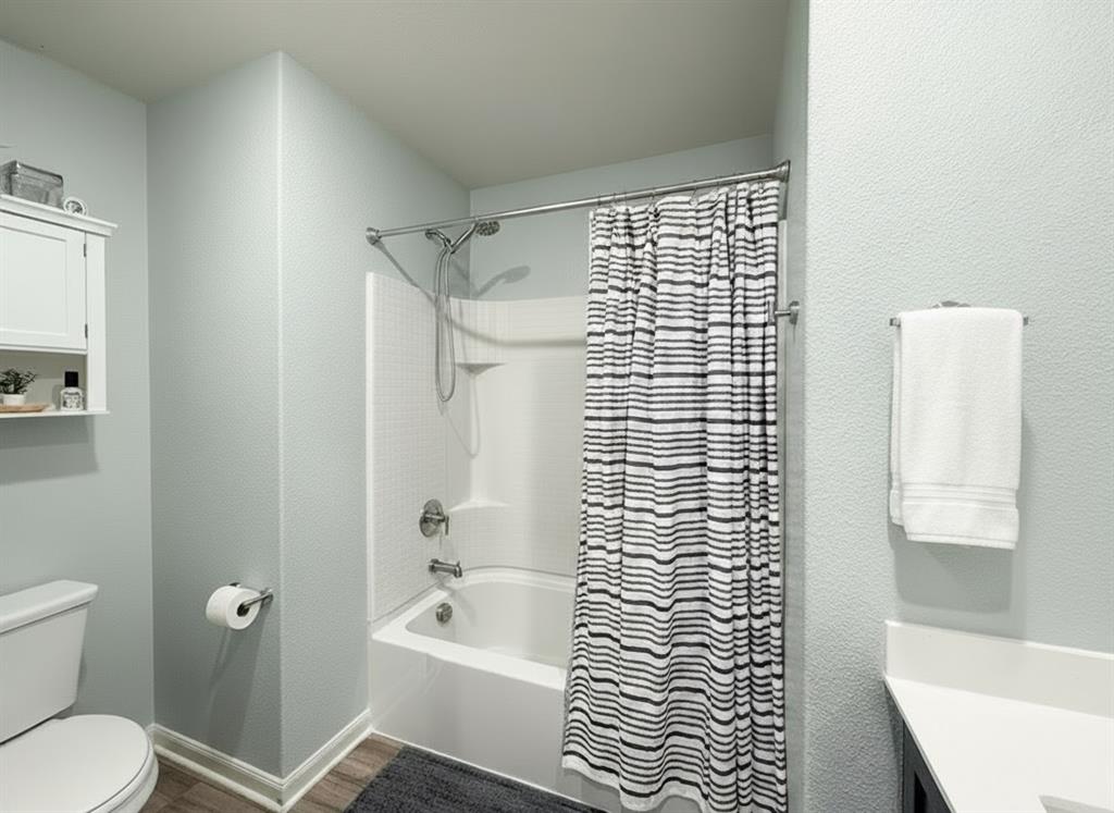 13507 Granite Park Road Ponder, TX 76259 - Photo 18 of 28 a bathroom with a bathtub and a shower
