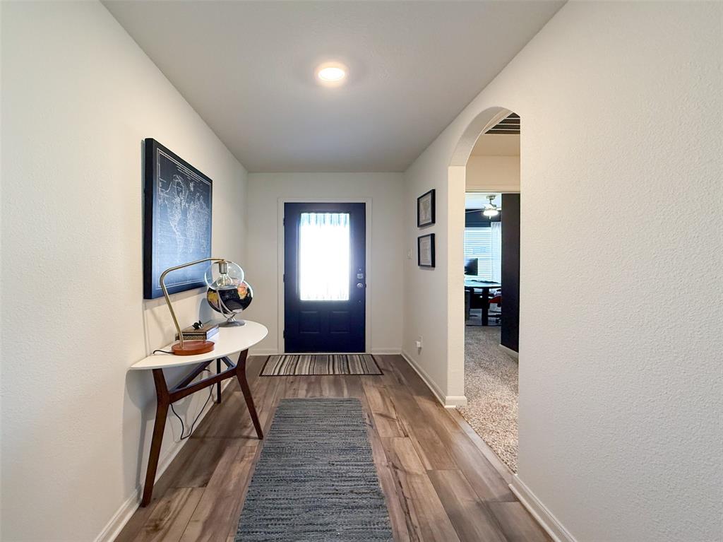 13507 Granite Park Road Ponder, TX 76259 - Photo 5 of 28 a view of a hallway with furniture and a window