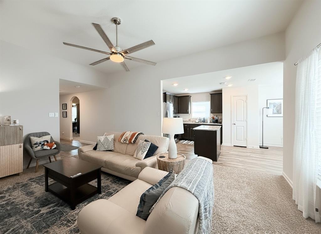 13507 Granite Park Road Ponder, TX 76259 - Photo 6 of 28 a living room with furniture and a chandelier