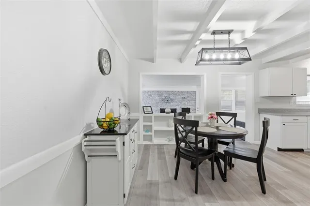 a view of a kitchen with dining table and chairs