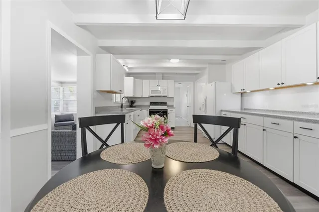 a view of a kitchen with electric appliances and cabinets