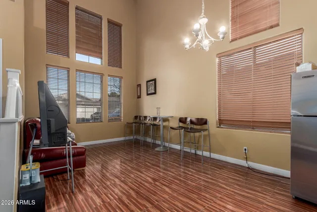 a living room with furniture a desk and chair with wooden floor