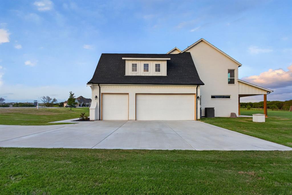 7798 Barber Rnch Road Fort Worth, TX 76126 - Photo 37 of 40 a front view of a house with a yard and garage