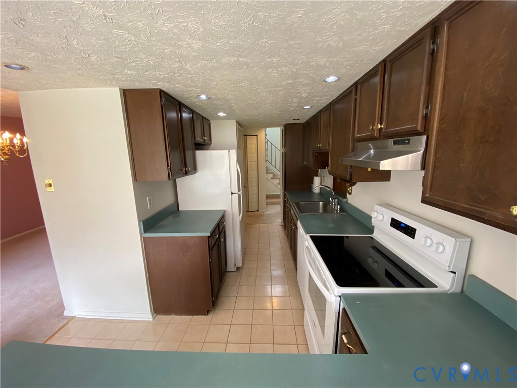 1507 Bronwyn Road, Unit 301 Henrico, VA 23238 - Photo 13 of 41 a kitchen with stainless steel appliances a refrigerator a sink a stove and white cabinets