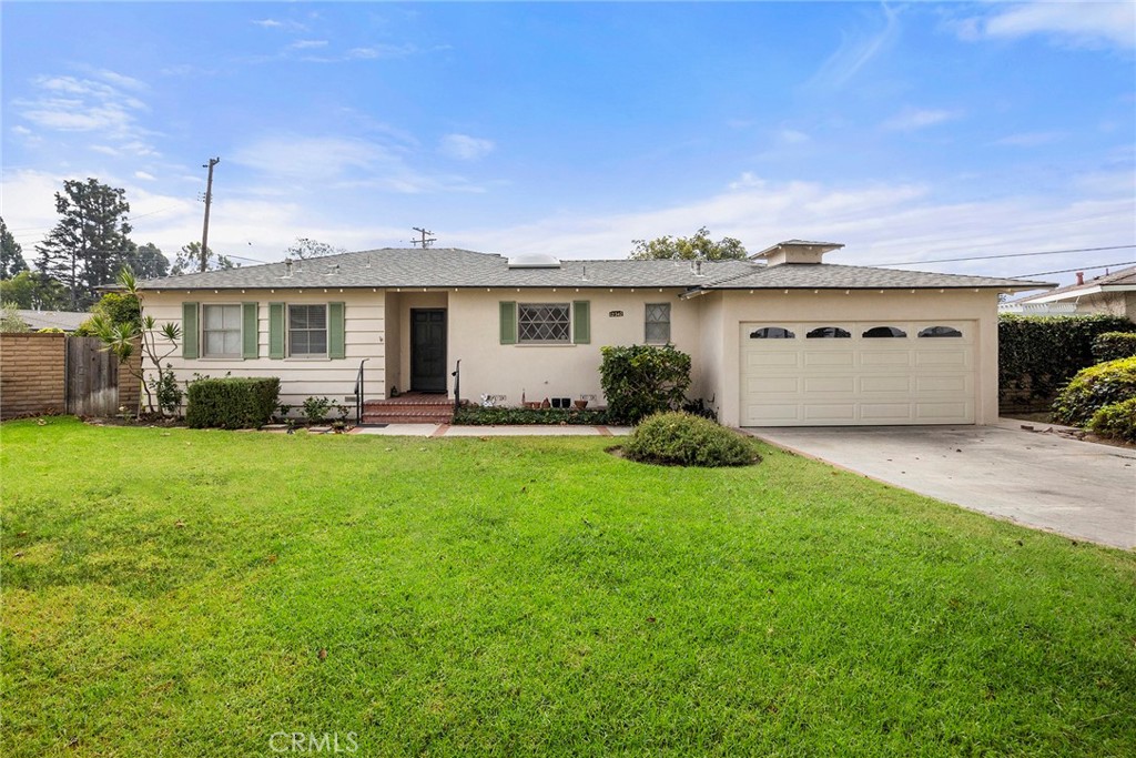 12342 Rea Circle Garden Grove, CA 92841 - Photo 1 of 27 a front view of a house with a garden and yard
