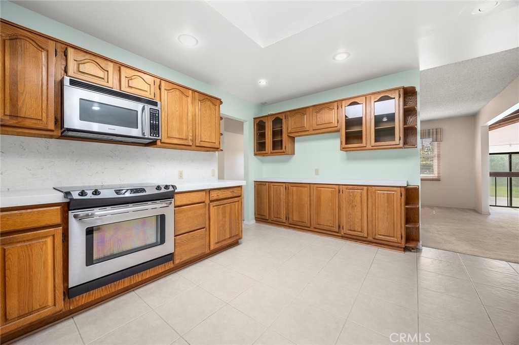 12342 Rea Circle Garden Grove, CA 92841 - Photo 11 of 27 a kitchen with stainless steel appliances granite countertop a stove a sink and a microwave