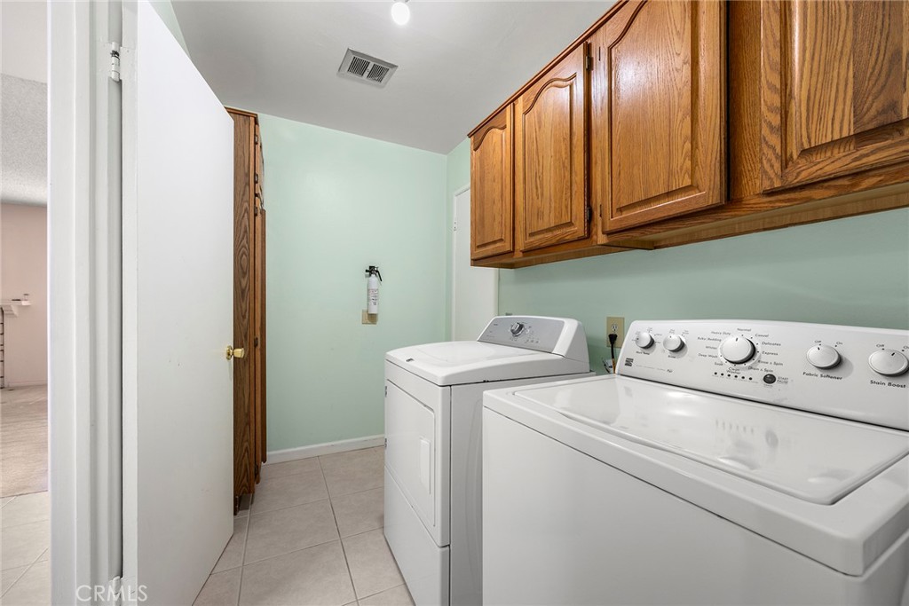 12342 Rea Circle Garden Grove, CA 92841 - Photo 12 of 27 a utility room with dryer and washer
