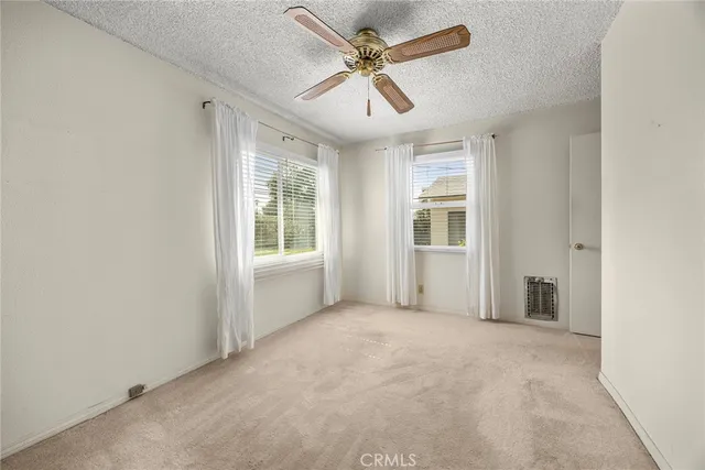 a view of an empty room with a ceiling fan