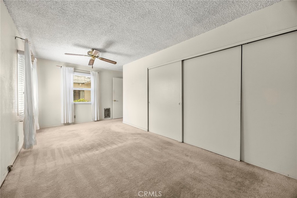 12342 Rea Circle Garden Grove, CA 92841 - Photo 19 of 27 a view of an empty room with a ceiling fan