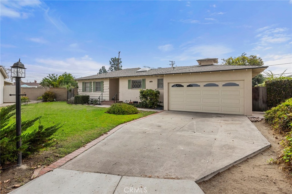 12342 Rea Circle Garden Grove, CA 92841 - Photo 2 of 27 a front view of a house with a yard and potted plants