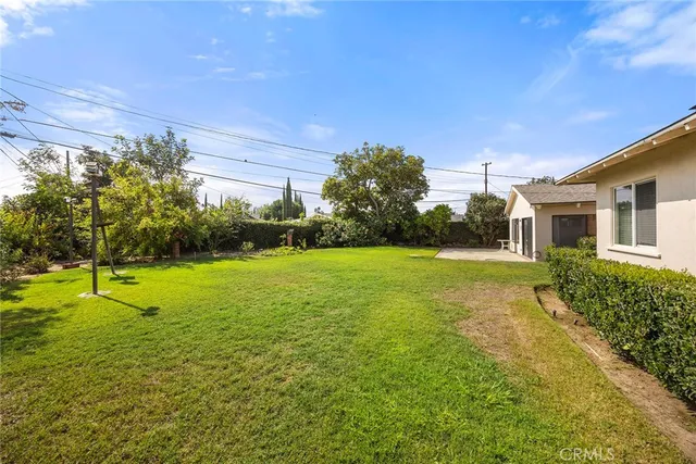 a backyard of a house with table and chairs