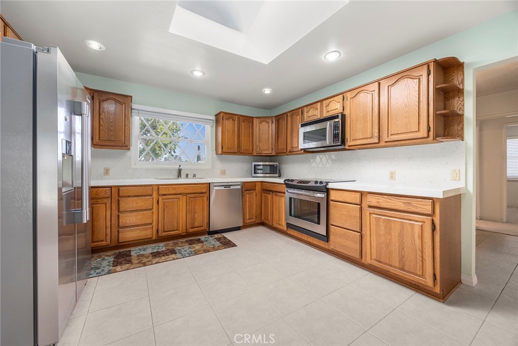 12342 Rea Circle Garden Grove, CA 92841 - Photo 10 of 27 a kitchen with stainless steel appliances granite countertop a stove sink and cabinets