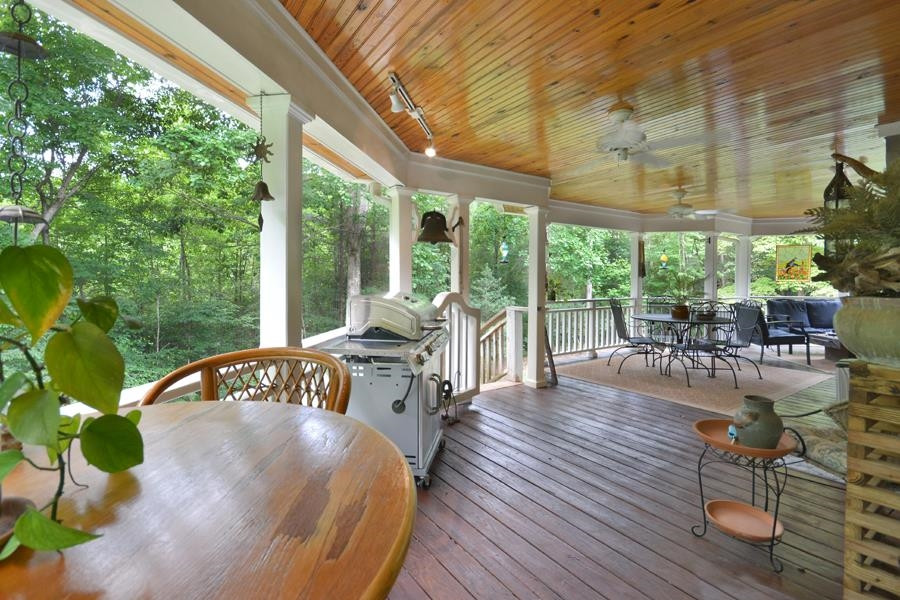 544 Lockamy Road Timberlake, NC 27583 - Photo 41 of 47 a view of a patio with table and chairs potted plants with wooden floor and fence