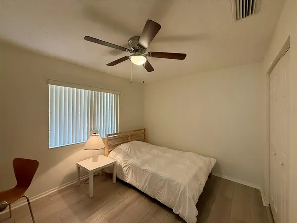 a bedroom with a bed and a window