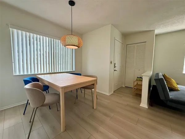a dining room with furniture and wooden floor