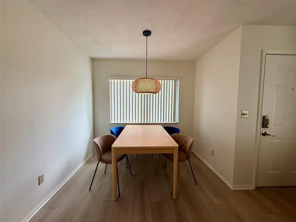 a room with a table chairs and wooden floor