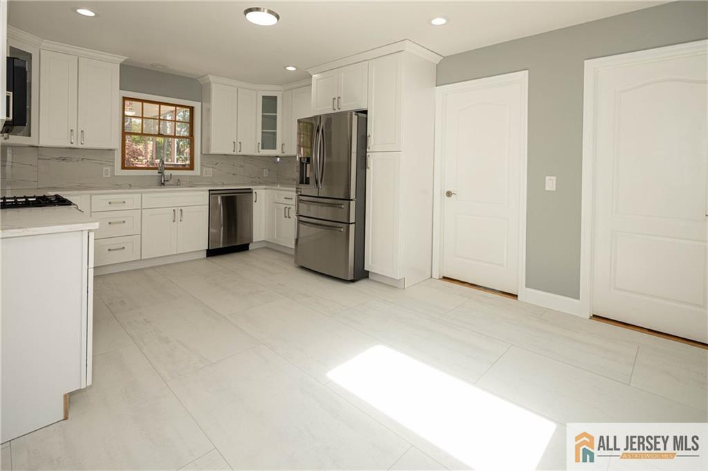 278 Rector Street Perth Amboy, NJ 08861 - Photo 7 of 47 a kitchen with refrigerator cabinets and furniture
