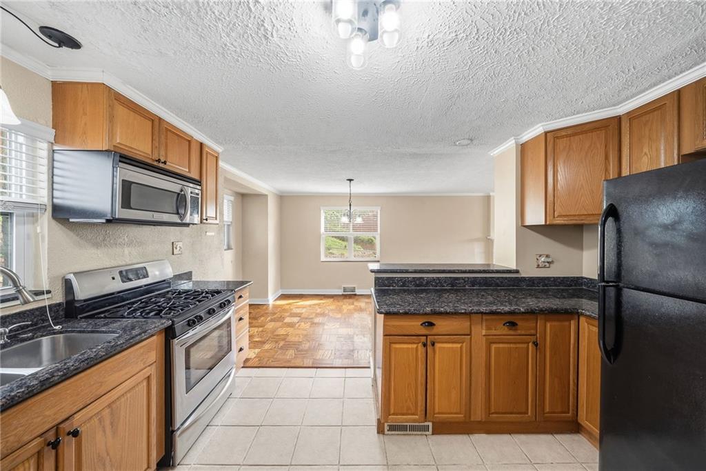 8 Allendale Place Pittsburgh, PA 15228 - Photo 12 of 34 a kitchen with stainless steel appliances granite countertop a stove sink and cabinets