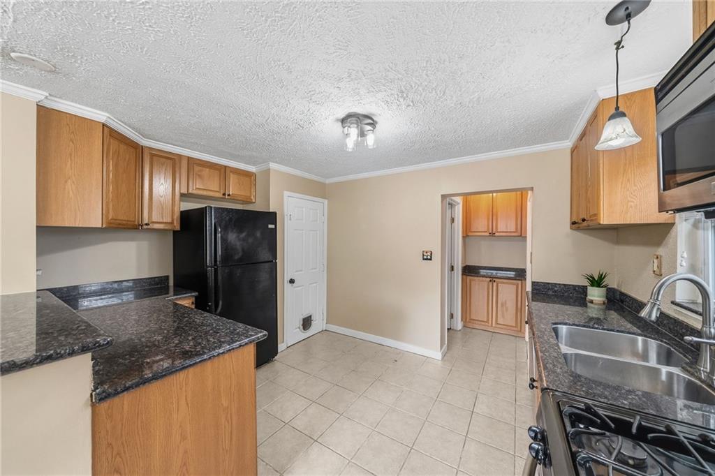 8 Allendale Place Pittsburgh, PA 15228 - Photo 13 of 34 a kitchen with granite countertop a refrigerator stove and sink
