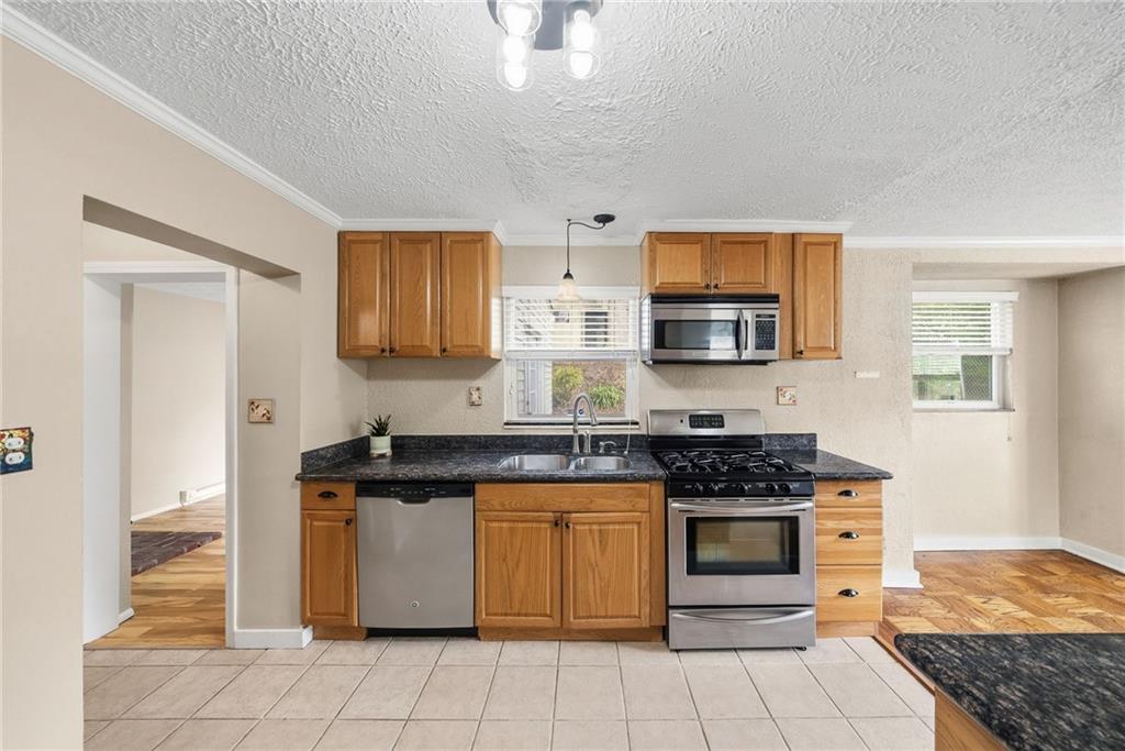 8 Allendale Place Pittsburgh, PA 15228 - Photo 14 of 34 a kitchen with stainless steel appliances granite countertop a stove a sink and a microwave