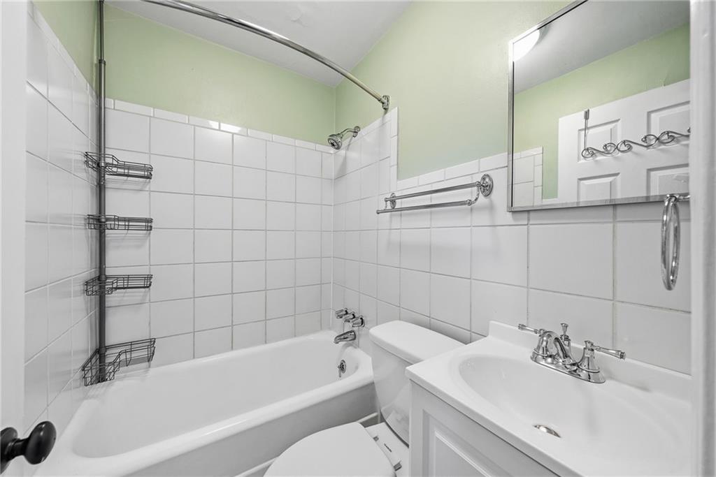 8 Allendale Place Pittsburgh, PA 15228 - Photo 21 of 34 a bathroom with a white bath tub sitting next to a white sink and vanity